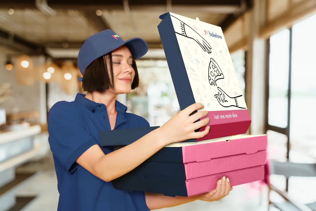 a woman in a blue shirt is holding a box.