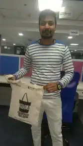 a man holding a bag in an office.