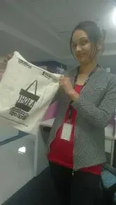 a woman holding a bag in a store.