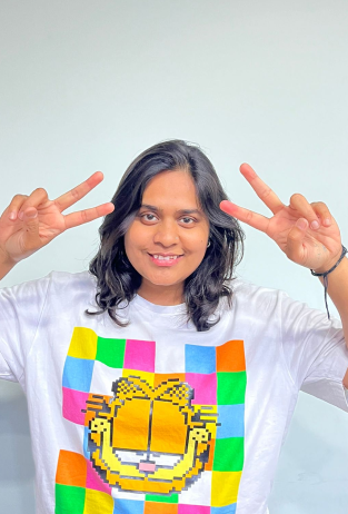 a woman making a peace sign with her hands.