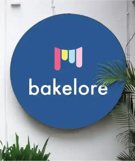a blue sign that has bakery name bakelore on it.